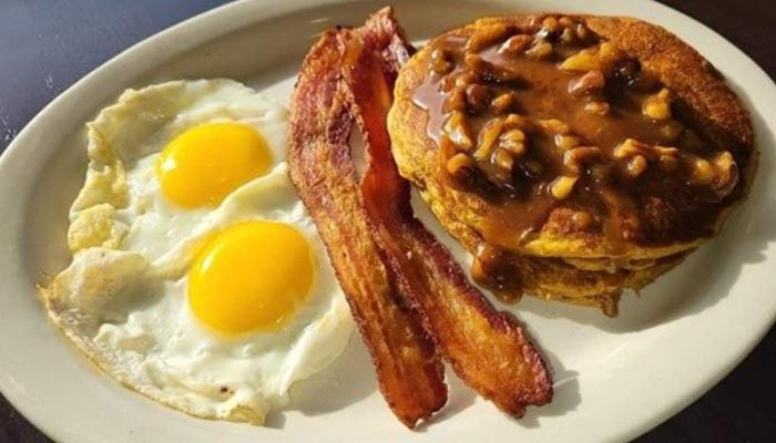 Ruby's Family Restaurant in Minnesota breakfast menu featuring two eggs sunny side up with bacon and caramel pecan pancakes