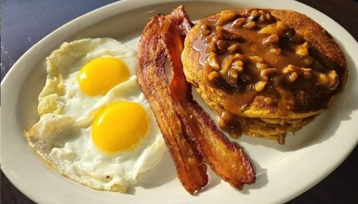 Ruby's Family Restaurant in Minnesota breakfast menu featuring two eggs sunny side up with bacon and caramel pecan pancakes